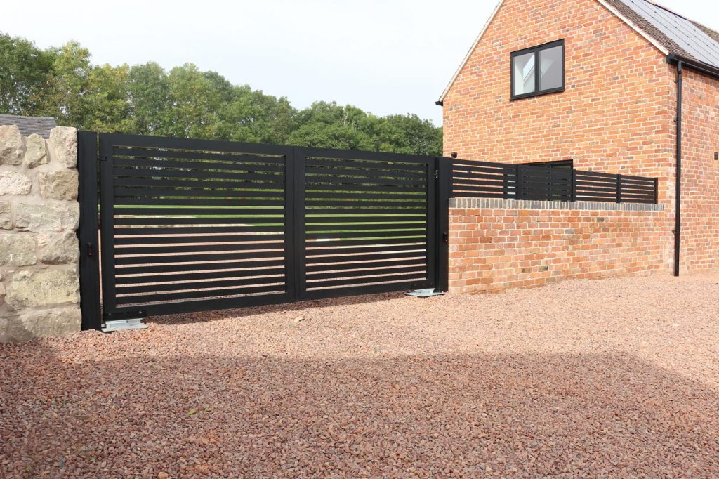 Automated aluminium swing gates with horizontal slat design installed at residential property