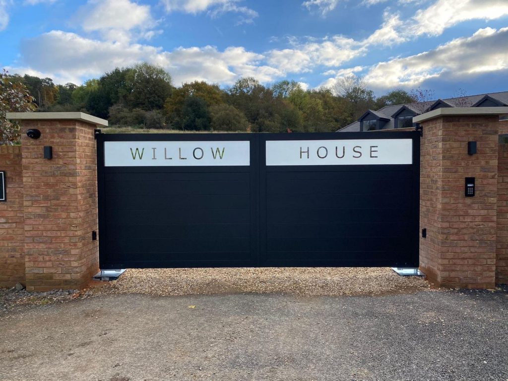 Custom automated entrance gates with property name signage for Willow House